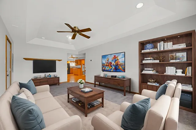 a living room with furniture a rug and a flat screen tv