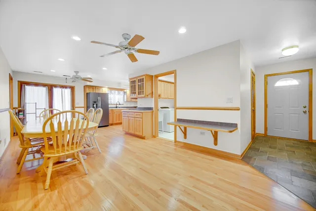 a view of a kitchen with wooden floor and electronic appliances