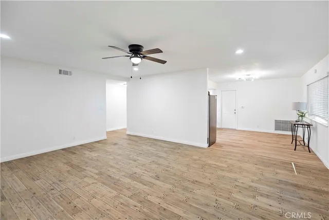 a view of a livingroom with a kitchen and a stove