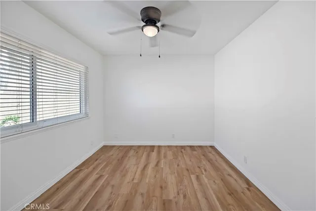 a view of room with hardwood floor and window