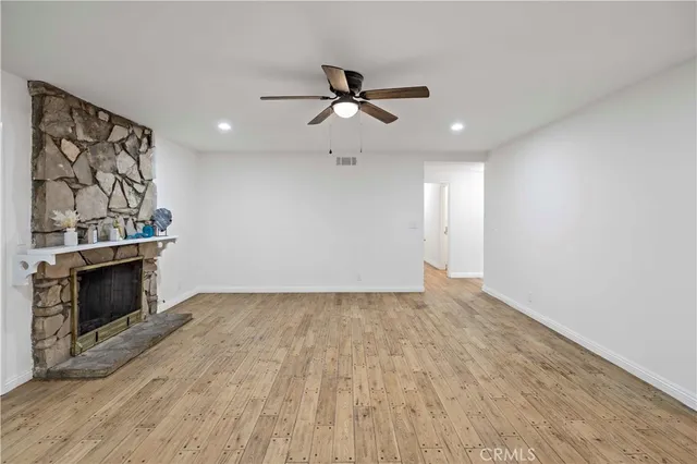 wooden floor in an empty room with a fireplace