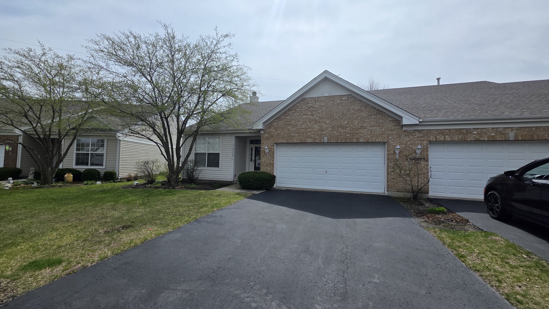 1426 Cambria Drive DeKalb, IL 60115 - Photo 2 of 3 a front view of a house with a yard and garage