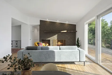 a view of empty room with wooden floor and fireplace