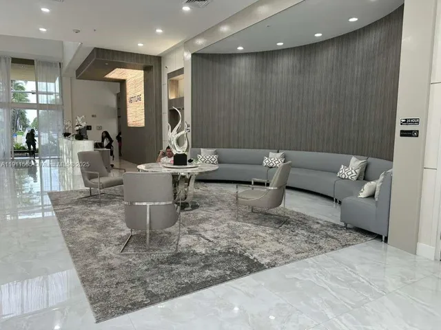 a living room with couches and kitchen view