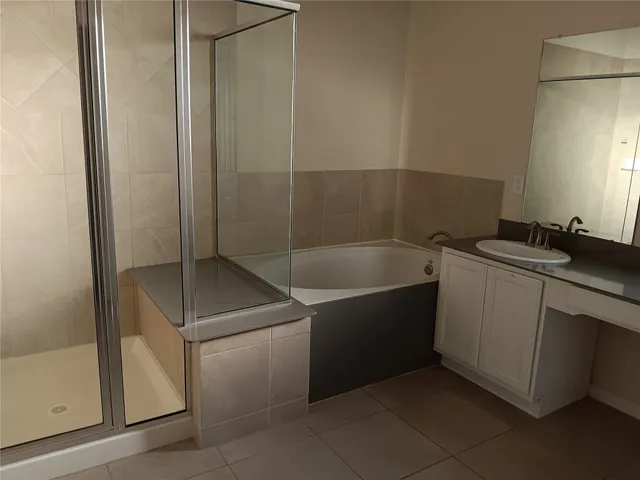 a bathroom with a shower and a sink
