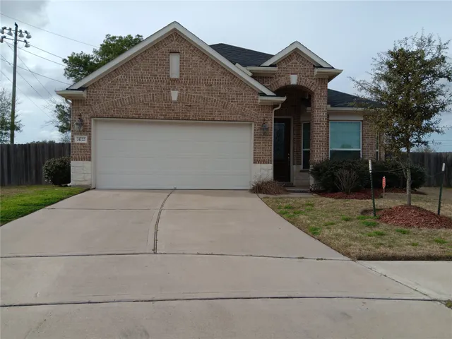 a front view of house with backyard and trees