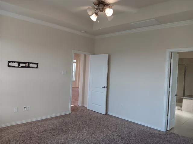 a view of an empty room with a fan