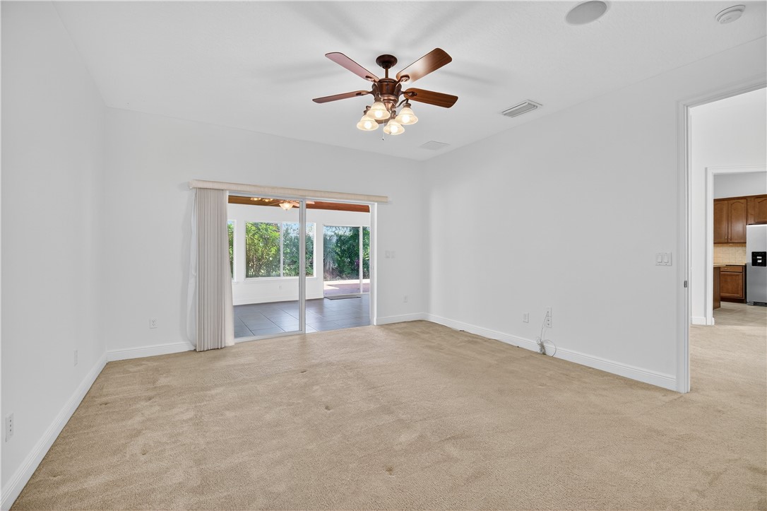 1712 Shakespeare Street Sebastian, FL 32958 - Photo 19 of 36 an empty room with ceiling fan and window