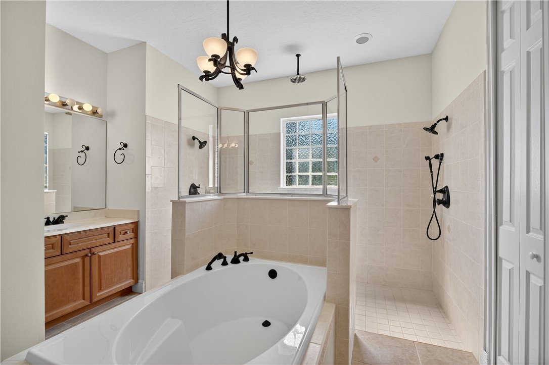 1712 Shakespeare Street Sebastian, FL 32958 - Photo 22 of 36 a bathroom with a tub sink shower and mirror