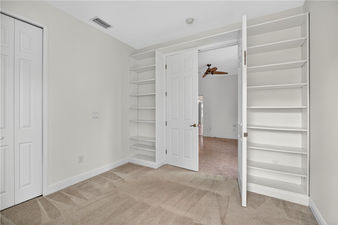 1712 Shakespeare Street Sebastian, FL 32958 - Photo 25 of 36 a view of walk in closet with empty racks