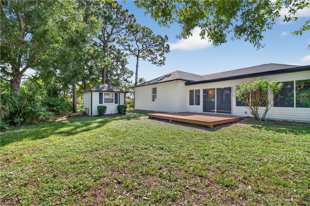 1712 Shakespeare Street Sebastian, FL 32958 - Photo 31 of 36 a backyard of a house with lots of green space