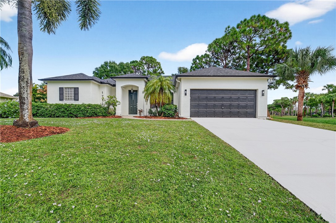 1712 Shakespeare Street Sebastian, FL 32958 - Photo 35 of 36 front view of a house with a yard