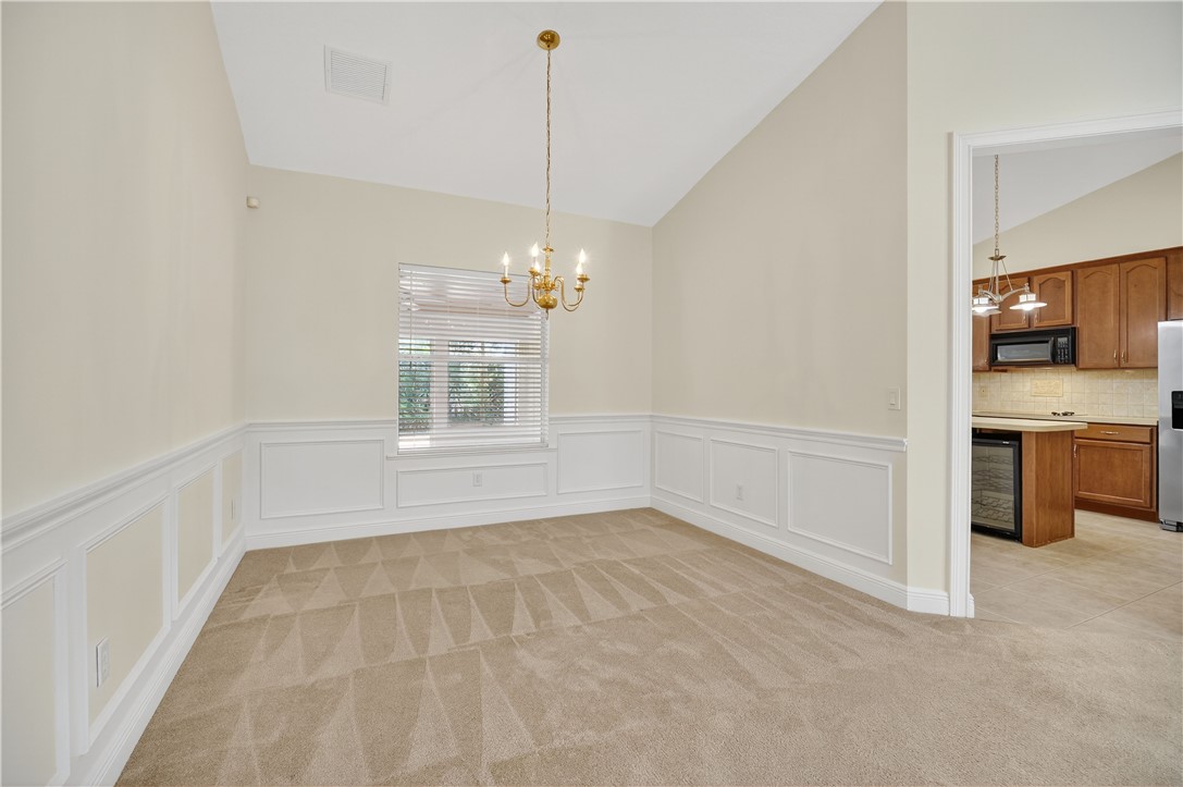 1712 Shakespeare Street Sebastian, FL 32958 - Photo 6 of 36 a view of an empty room with a kitchen