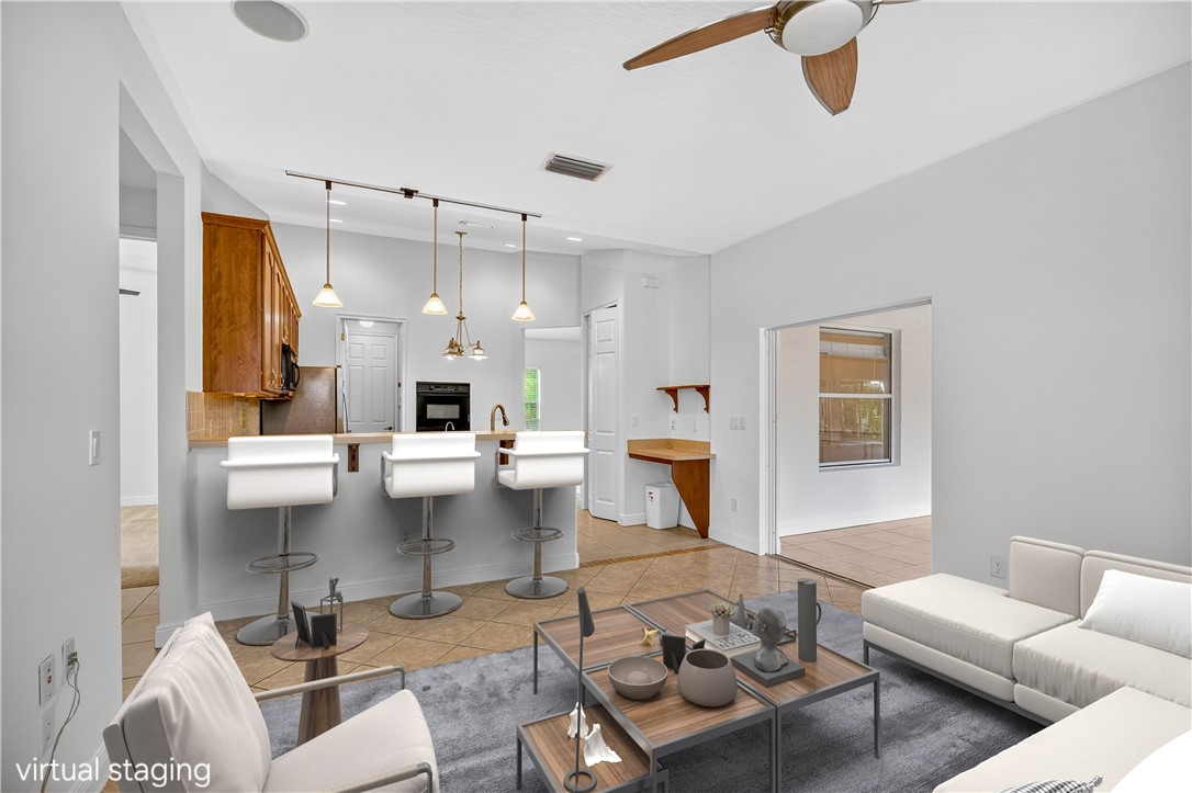 1712 Shakespeare Street Sebastian, FL 32958 - Photo 9 of 36 a living room with furniture and a chandelier