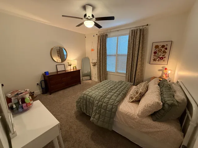 a bedroom with bed and a chandelier