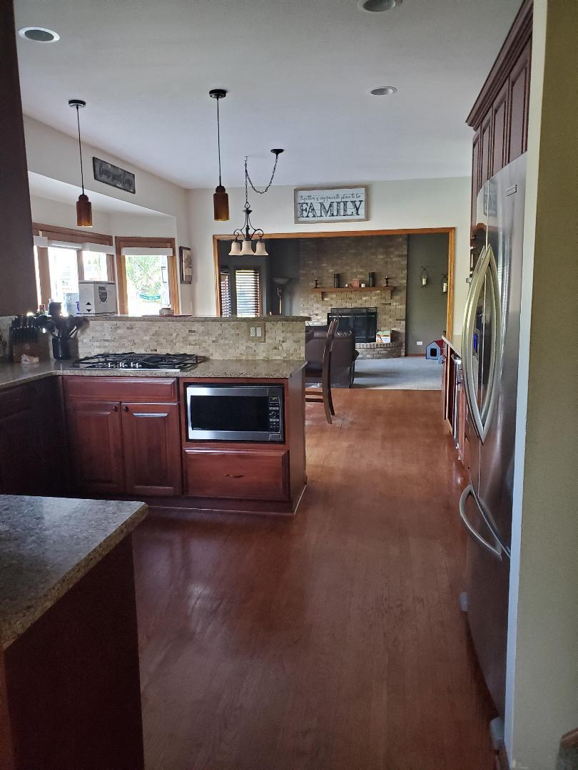 1385 Stonegate Road Algonquin, IL 60102 - Photo 11 of 32 a open kitchen with stainless steel appliances granite countertop a sink stove and refrigerator