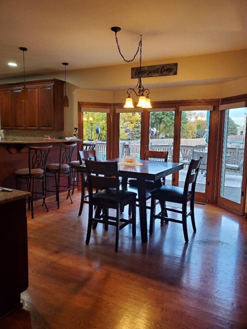 1385 Stonegate Road Algonquin, IL 60102 - Photo 14 of 32 a view of a dining room with furniture window and wooden floor