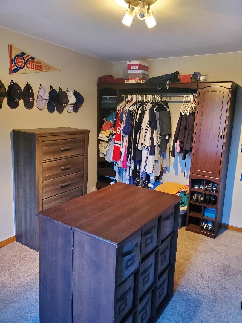 1385 Stonegate Road Algonquin, IL 60102 - Photo 20 of 32 a view of walk in closet with clothes
