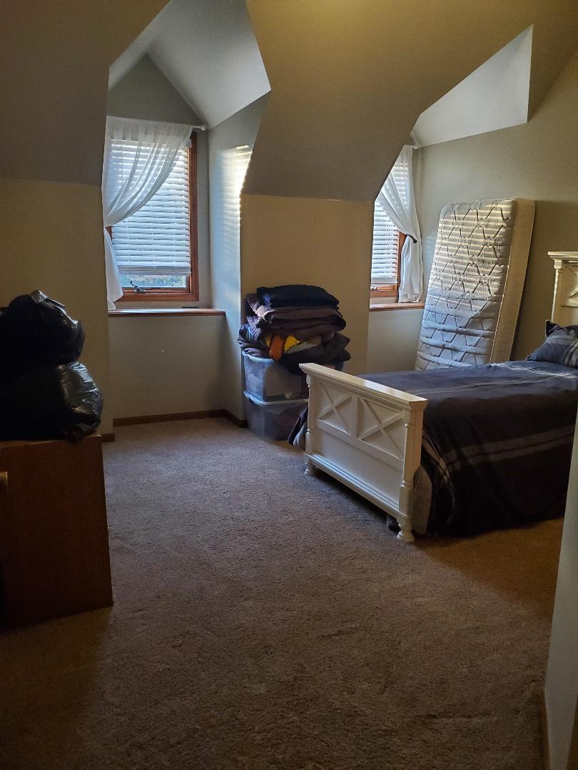 1385 Stonegate Road Algonquin, IL 60102 - Photo 27 of 32 a living room with furniture and a window