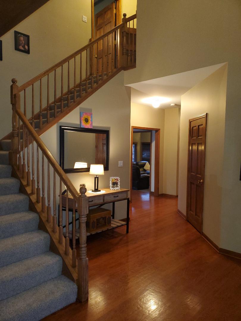 1385 Stonegate Road Algonquin, IL 60102 - Photo 7 of 32 a view of entryway and hall with wooden floor