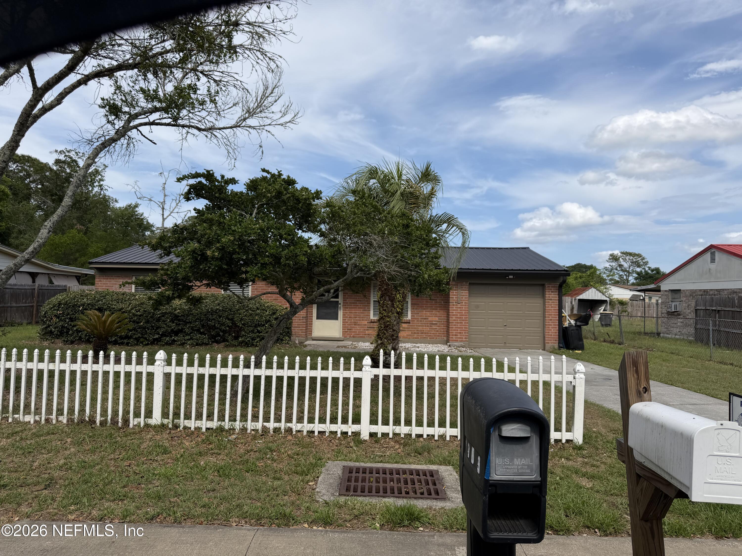 7539 Walden Road Jacksonville, FL 32244 - Photo 5 of 18 a front view of a house with a garden