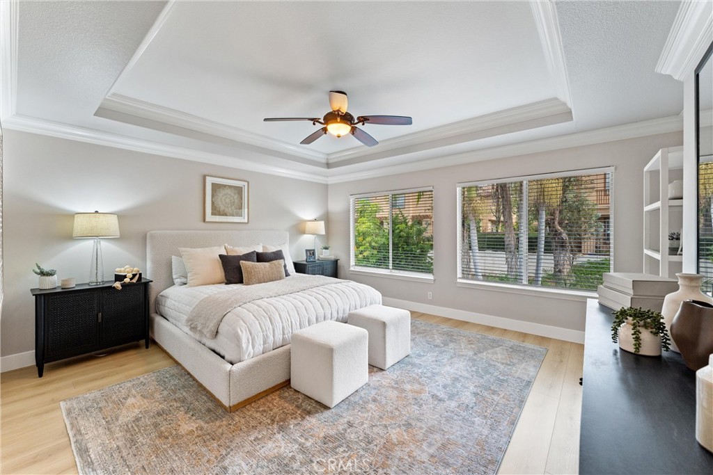 2741 Timmons Tustin, CA 92782 - Photo 19 of 30 a spacious bedroom with a large bed and a couch