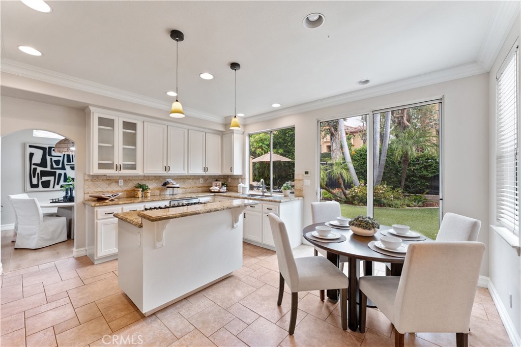 2741 Timmons Tustin, CA 92782 - Photo 8 of 30 a kitchen with a dining table chairs and large windows