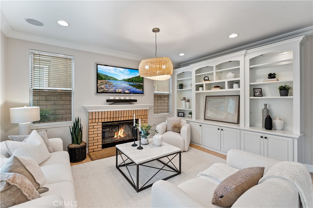 2741 Timmons Tustin, CA 92782 - Photo 9 of 30 a living room with furniture a fireplace and a flat screen tv