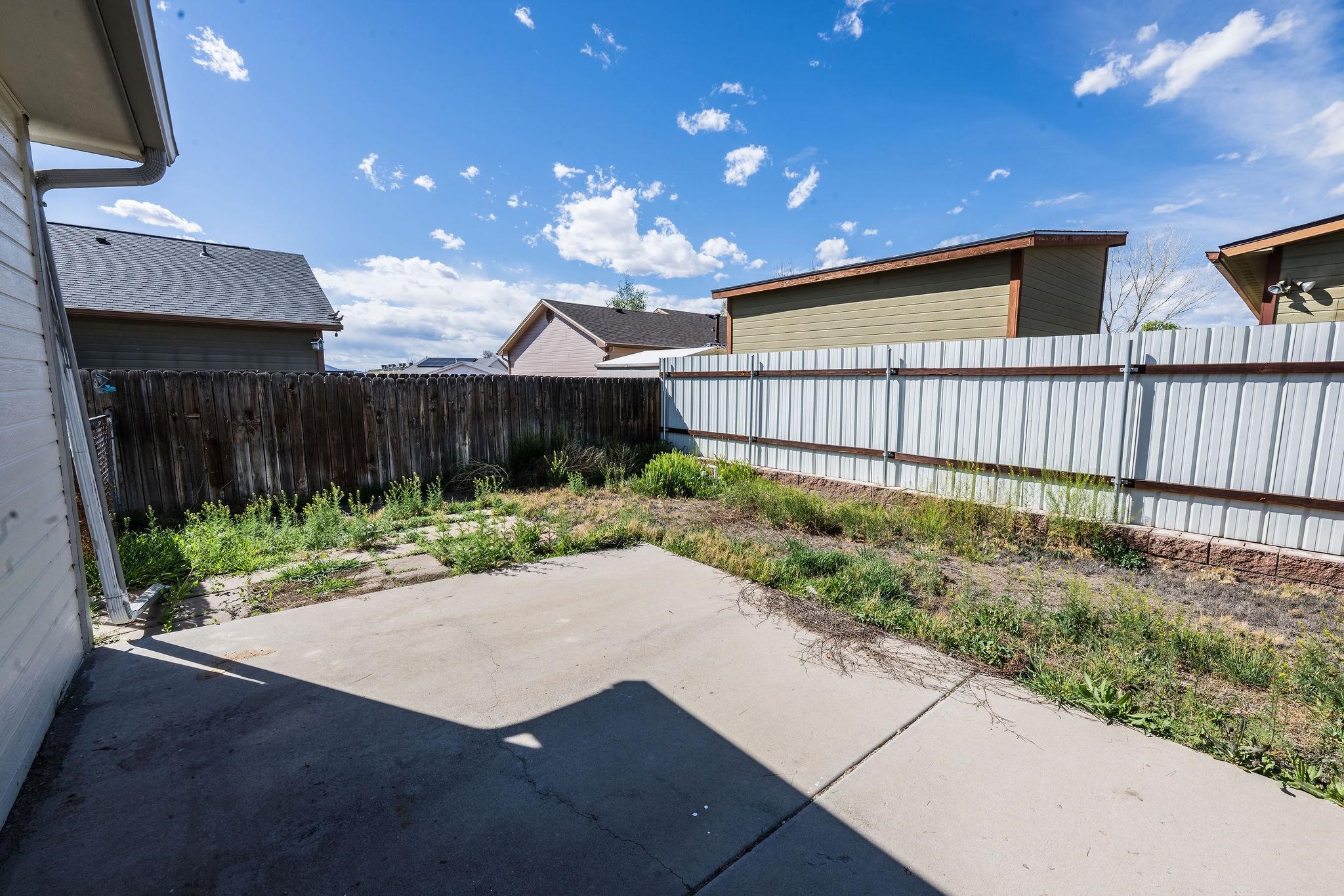 455 David Court Fruita, CO 81521 - Photo 17 of 28 a view of backyard with plants and wooden fence