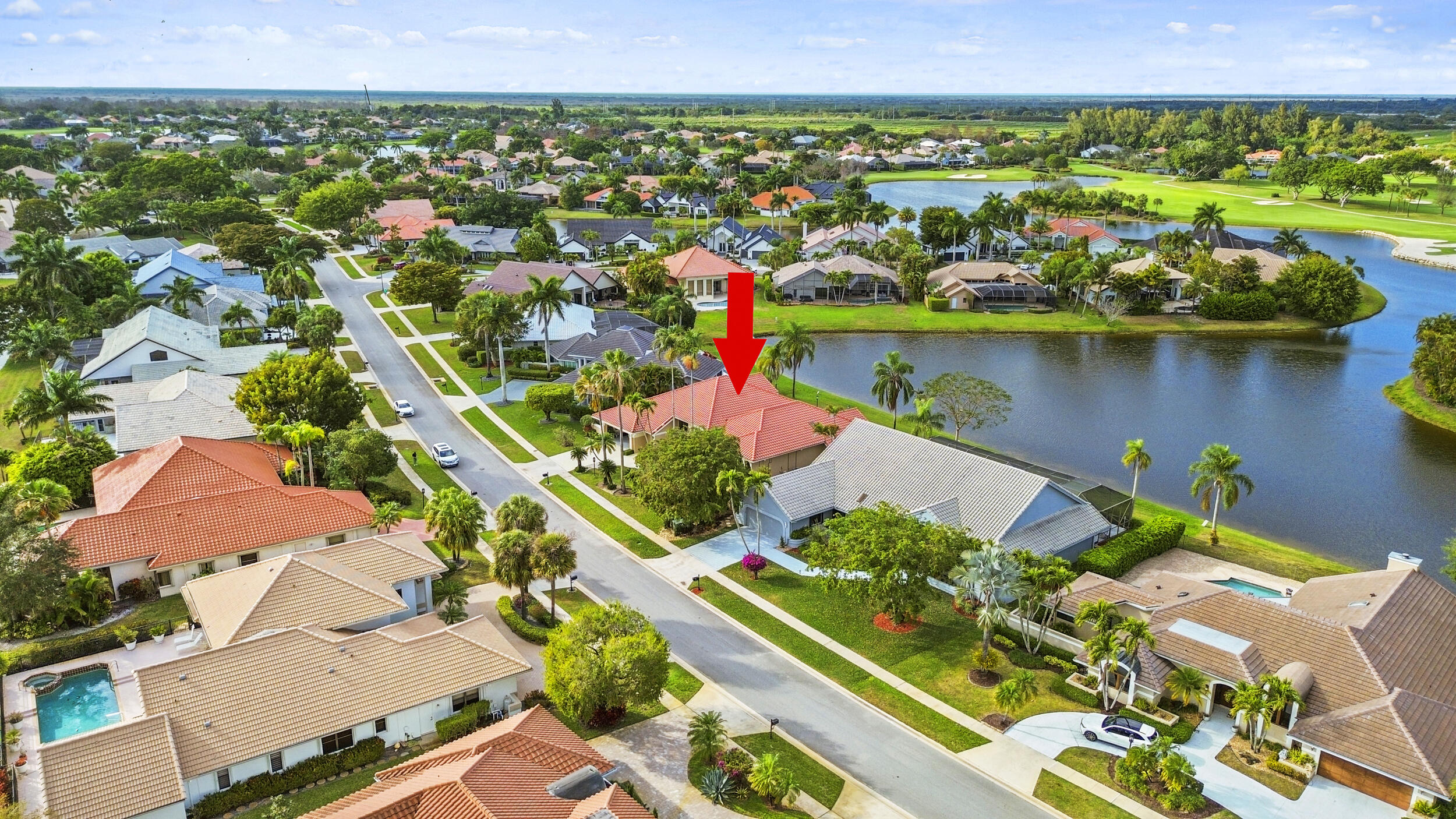 10747 Stonebridge Boulevard Boca Raton, FL 33498 - Photo 60 of 75 an aerial view of a house with a yard and lake view