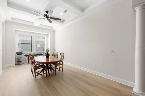 a view of a dining room with furniture and wooden floor