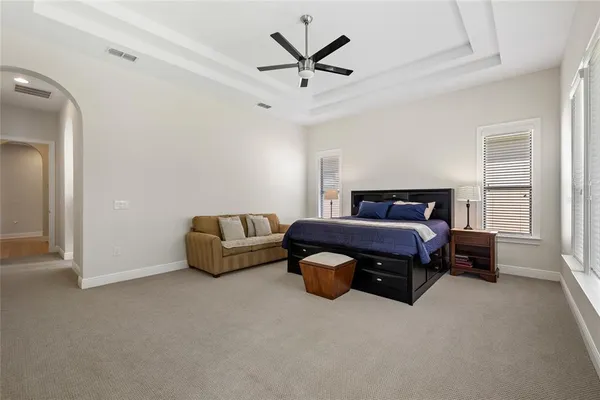a bedroom with bed and a ceiling fan