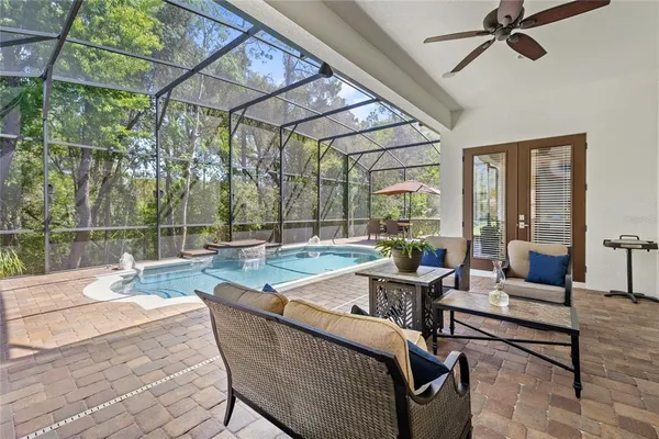 a outdoor space with patio the couches and a dining table with the view of swimming pool