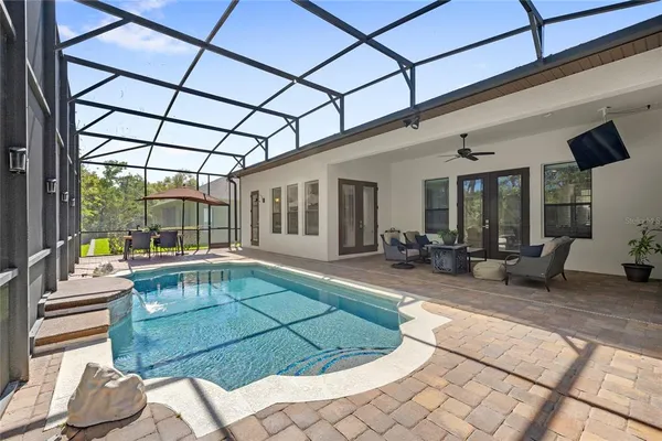 a swimming pool with outdoor seating