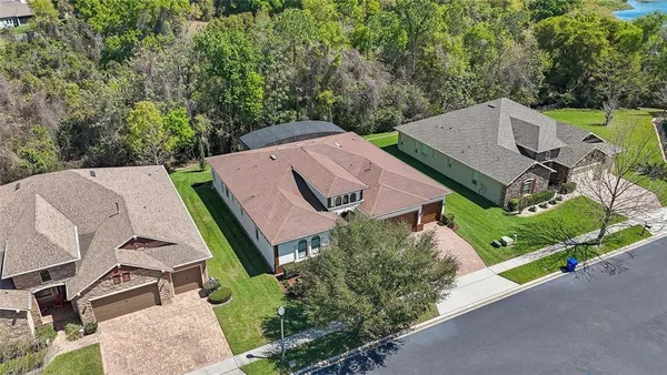 an aerial view of a house with garden space and street view