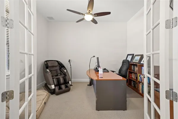 a view of a workspace with furniture and a window