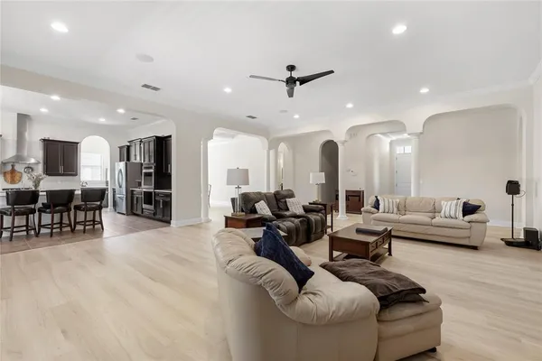a living room with furniture and wooden floor