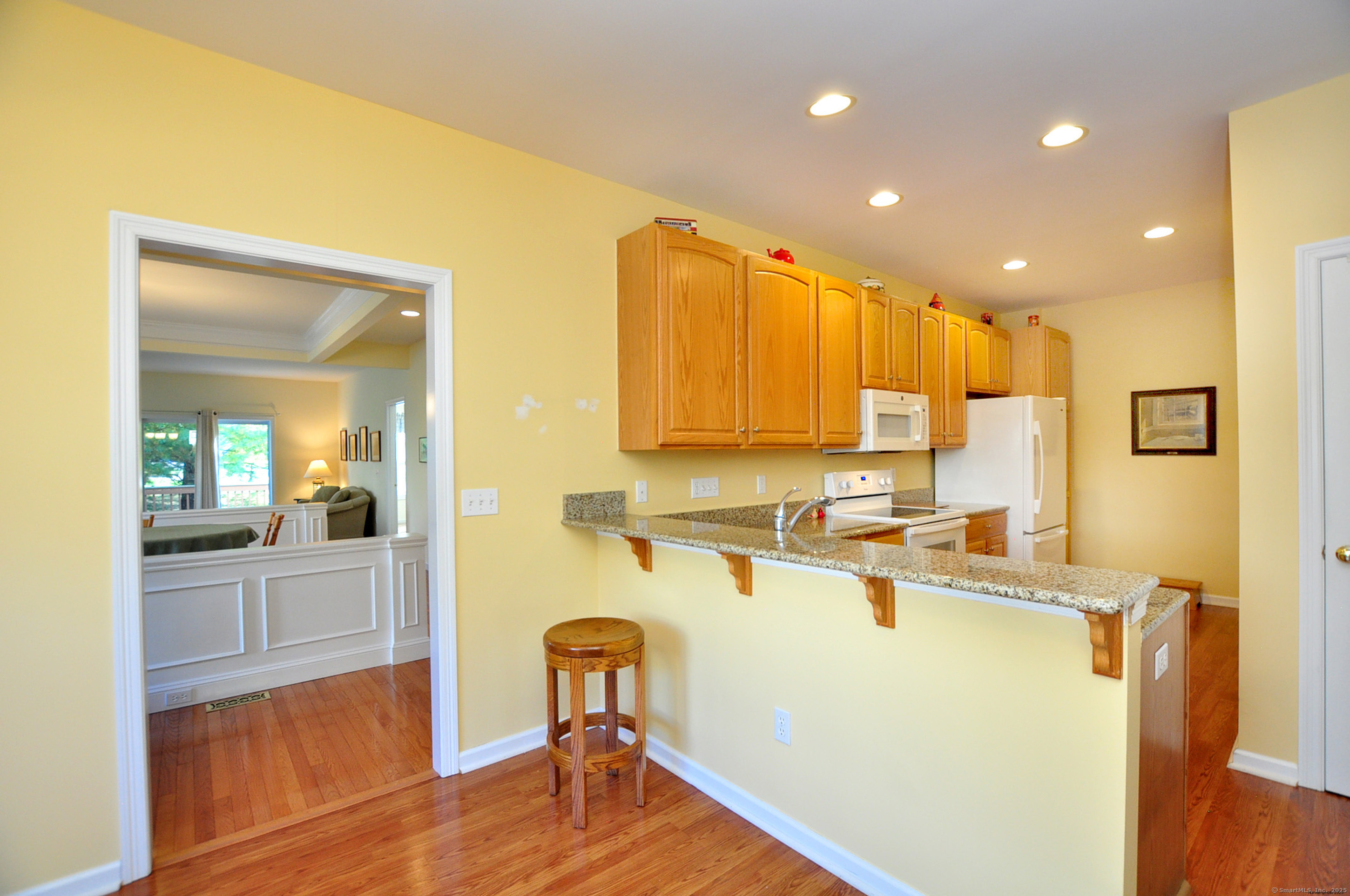 77 Carlson Ridge Road, Unit 77 New Milford, CT 06776 - Photo 14 of 40 a kitchen with a refrigerator a sink and cabinets