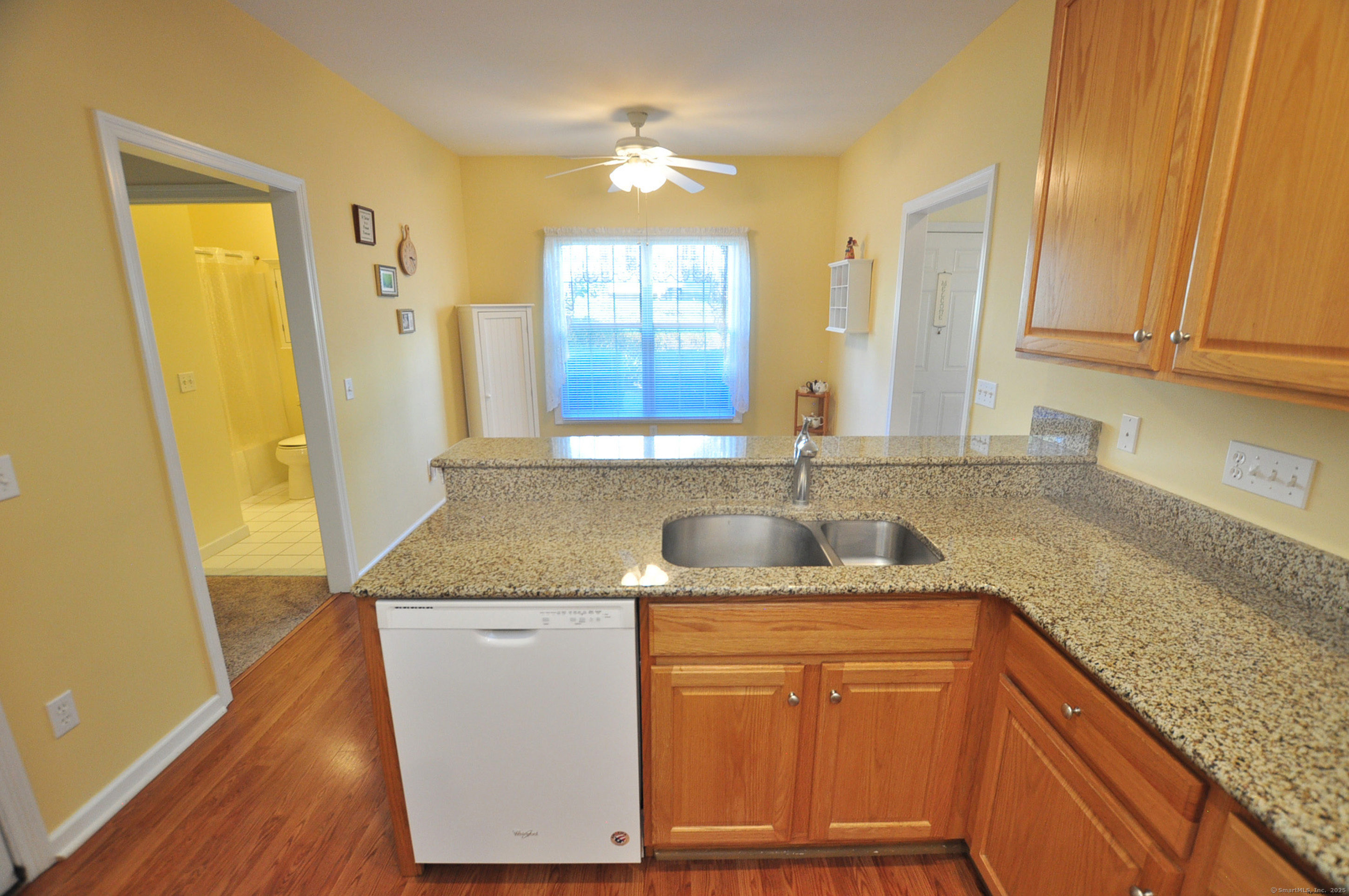 77 Carlson Ridge Road, Unit 77 New Milford, CT 06776 - Photo 20 of 40 a kitchen with granite countertop cabinets sink and window