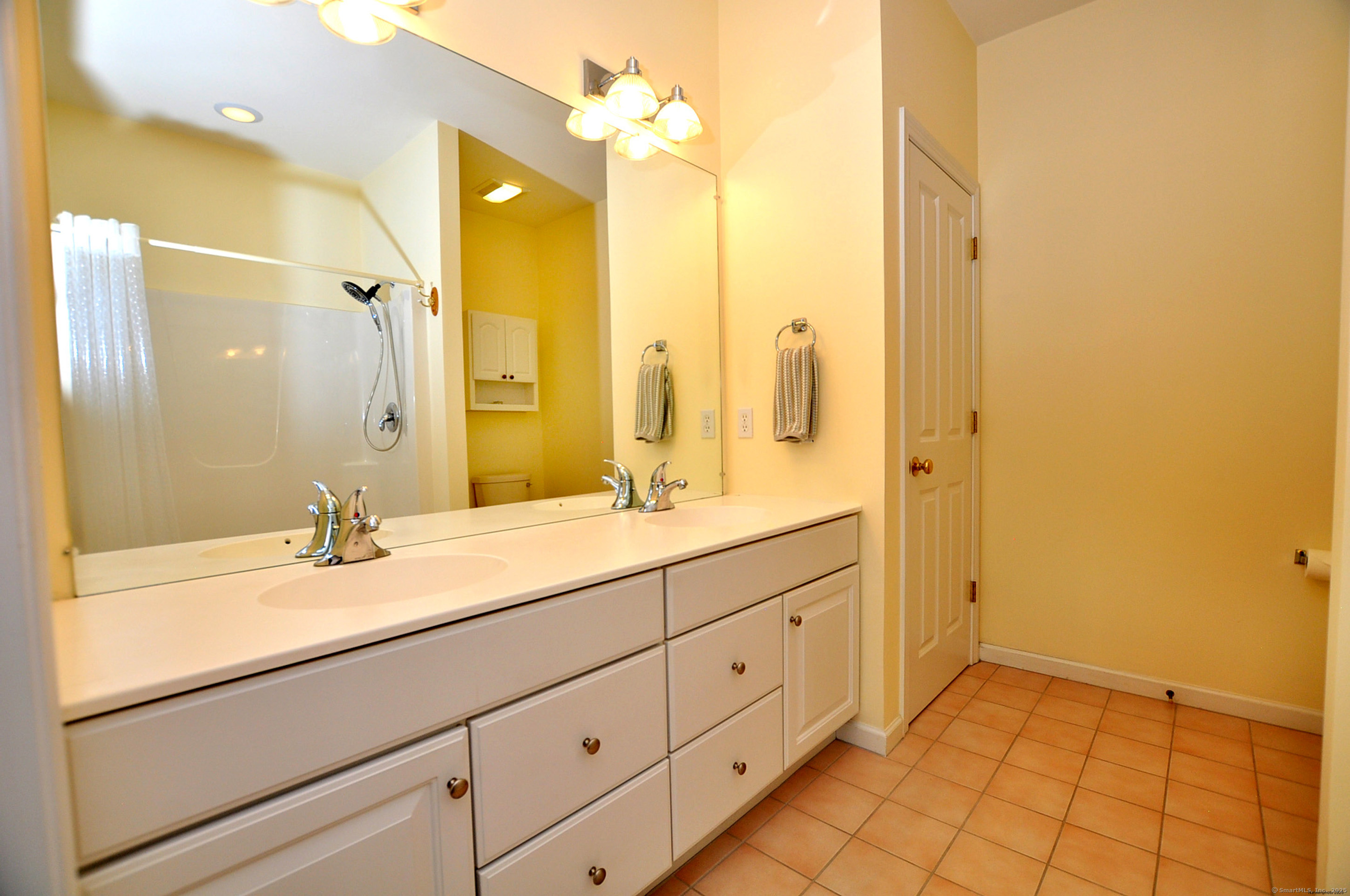 77 Carlson Ridge Road, Unit 77 New Milford, CT 06776 - Photo 28 of 40 a bathroom with a granite countertop sink mirror and double