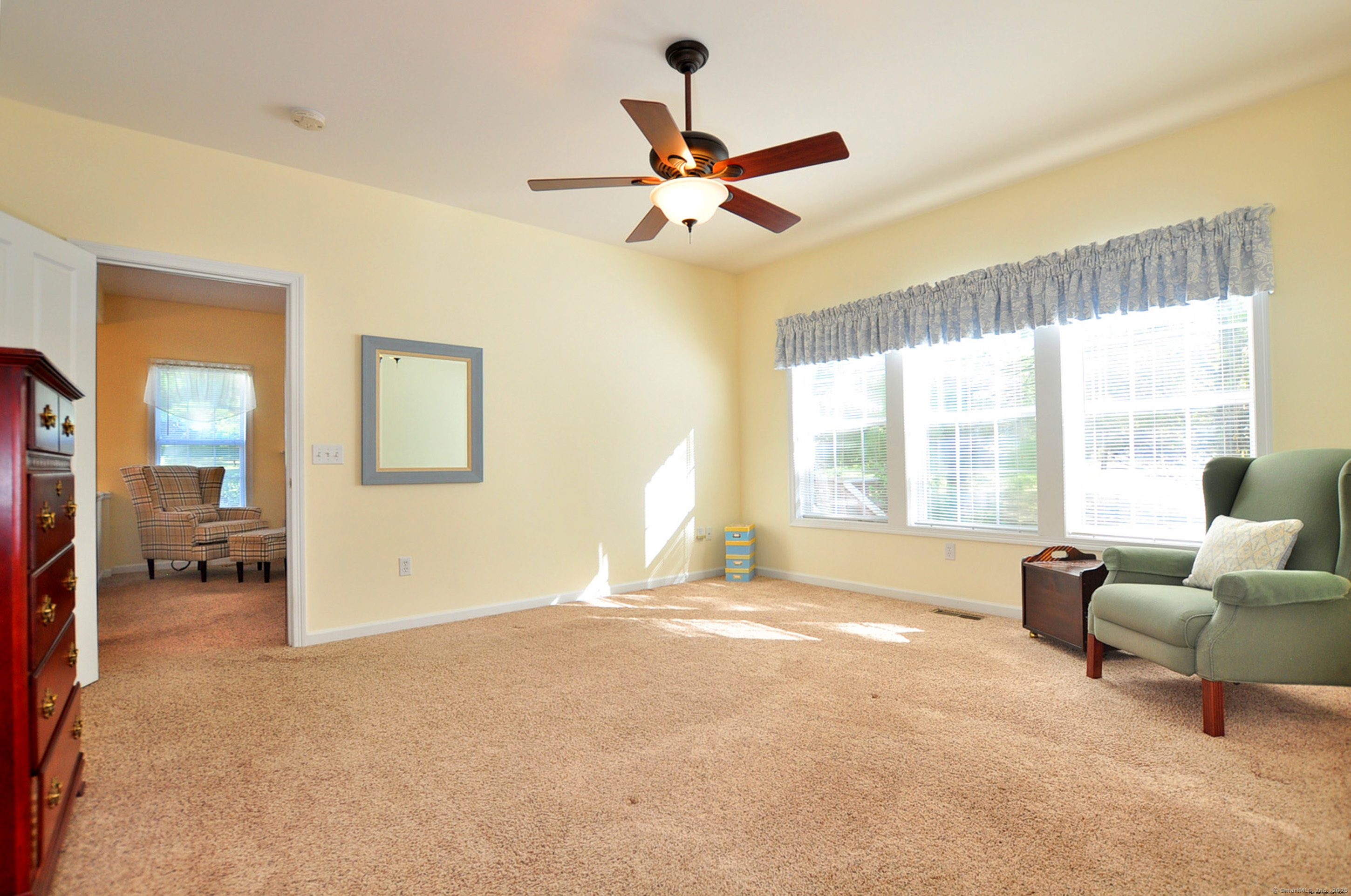 77 Carlson Ridge Road, Unit 77 New Milford, CT 06776 - Photo 30 of 40 a living room with furniture and a large window