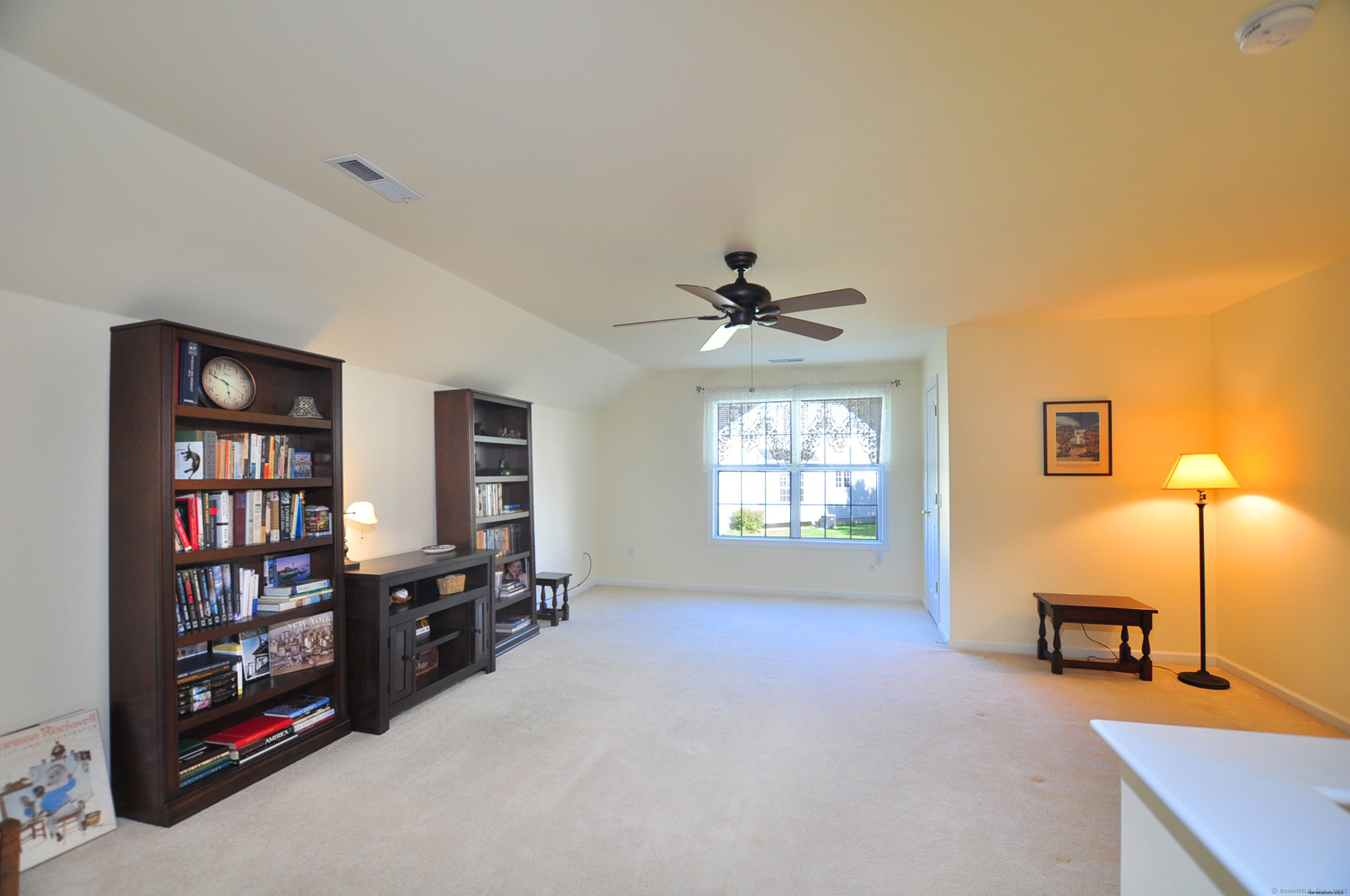 77 Carlson Ridge Road, Unit 77 New Milford, CT 06776 - Photo 33 of 40 a living room with furniture a window and a flat screen tv