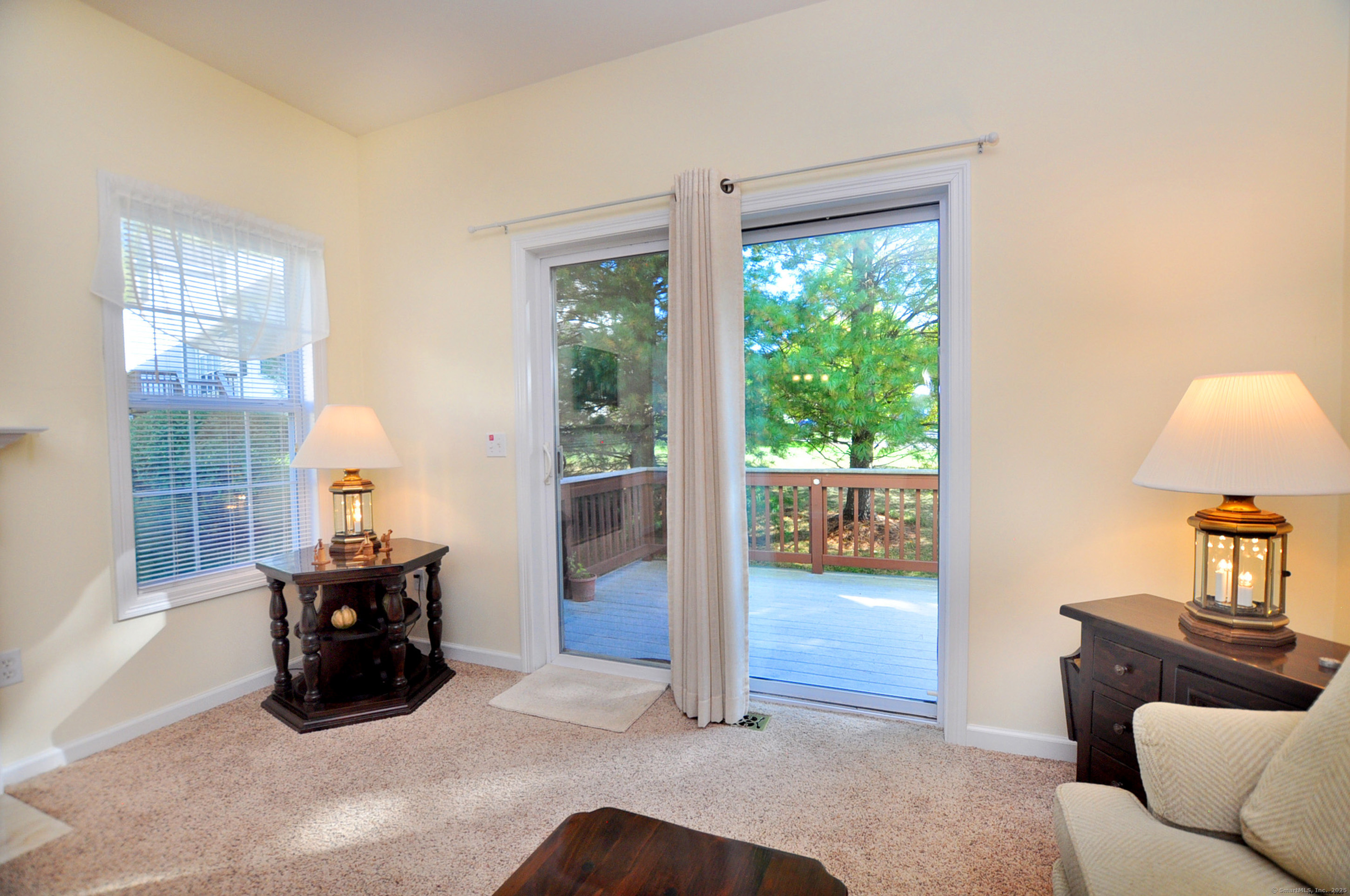 77 Carlson Ridge Road, Unit 77 New Milford, CT 06776 - Photo 35 of 40 a living room with furniture and a large window