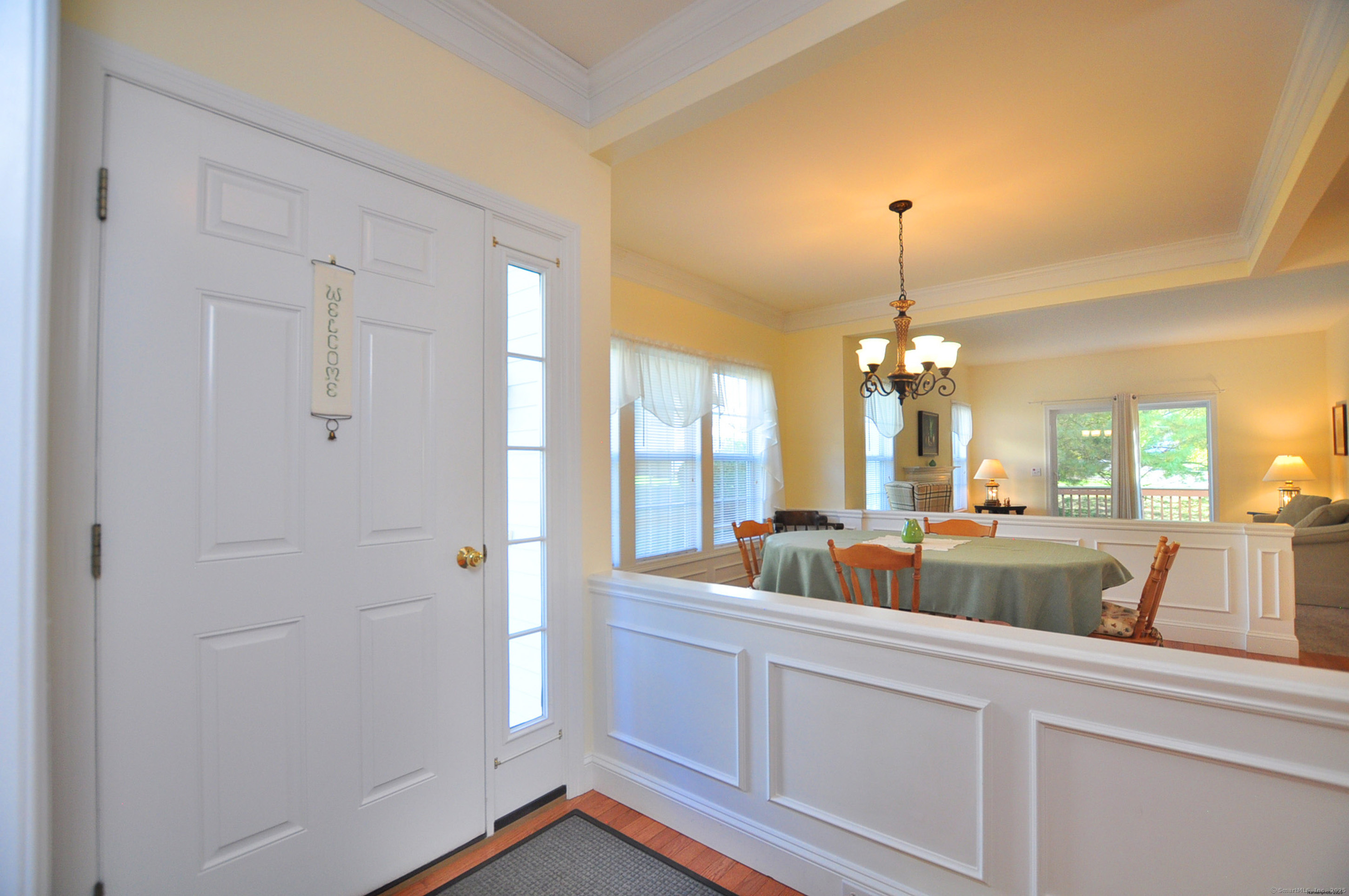 77 Carlson Ridge Road, Unit 77 New Milford, CT 06776 - Photo 5 of 40 a very nice looking room with a large window and chandelier