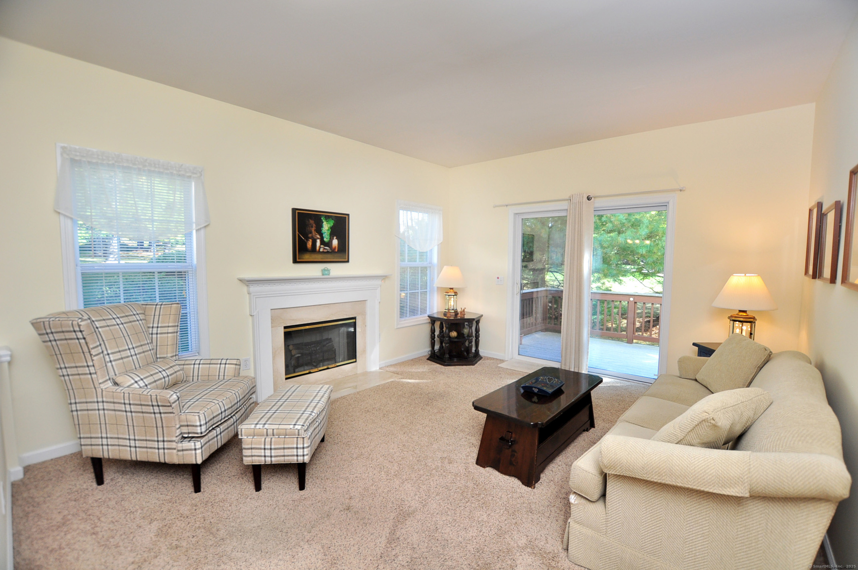 77 Carlson Ridge Road, Unit 77 New Milford, CT 06776 - Photo 9 of 40 a living room with furniture and a fireplace