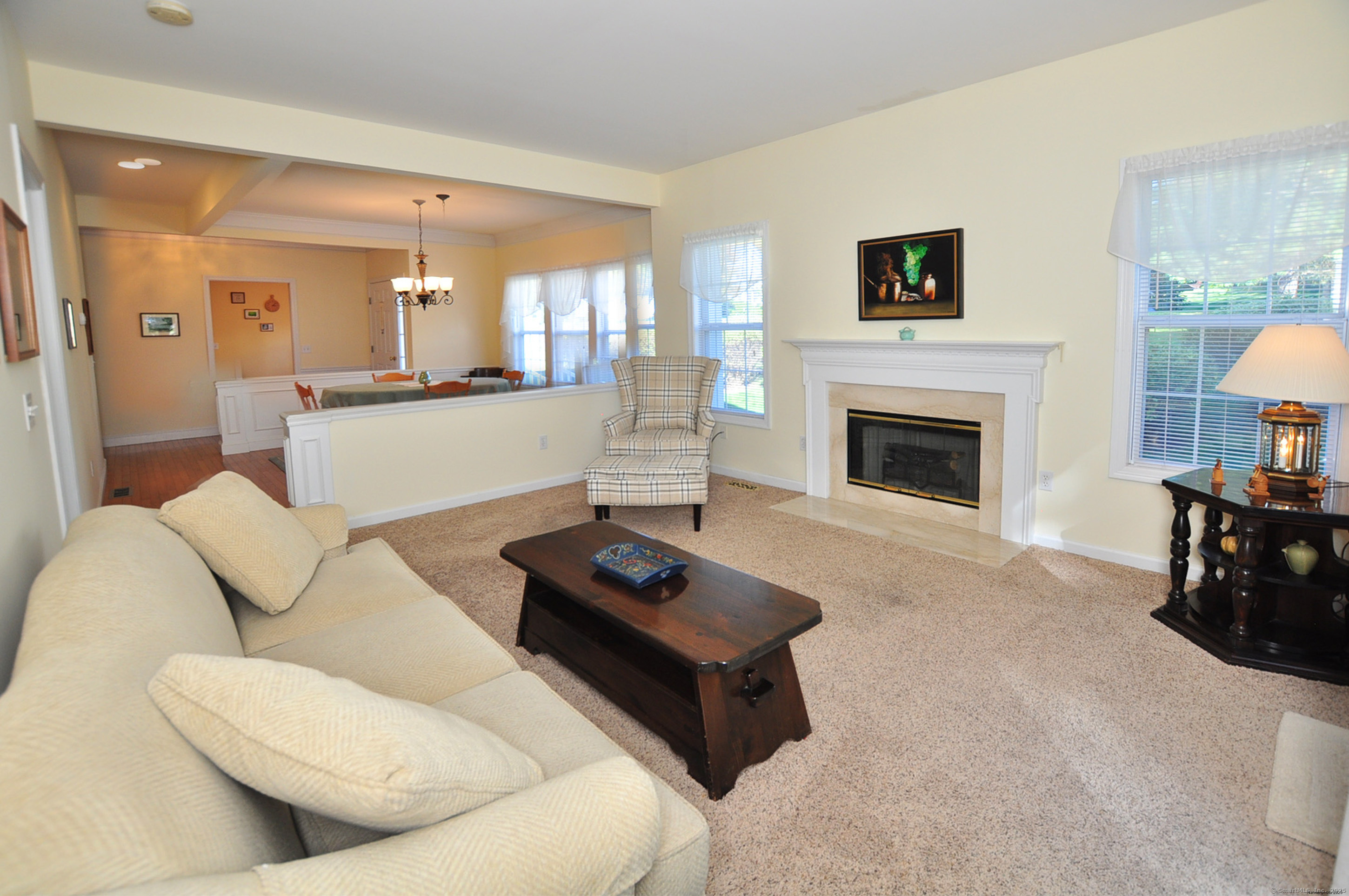 77 Carlson Ridge Road, Unit 77 New Milford, CT 06776 - Photo 10 of 40 a living room with furniture and a fireplace