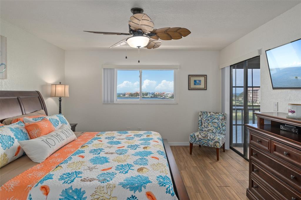 8211 Brent Street, Unit 847 Port Richey, FL 34668 - Photo 21 of 29 a bedroom with a bed and wooden floor