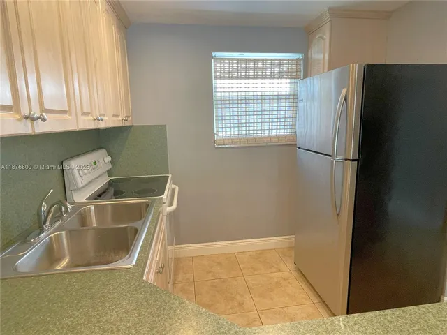 a view of a kitchen that has a sink and a window