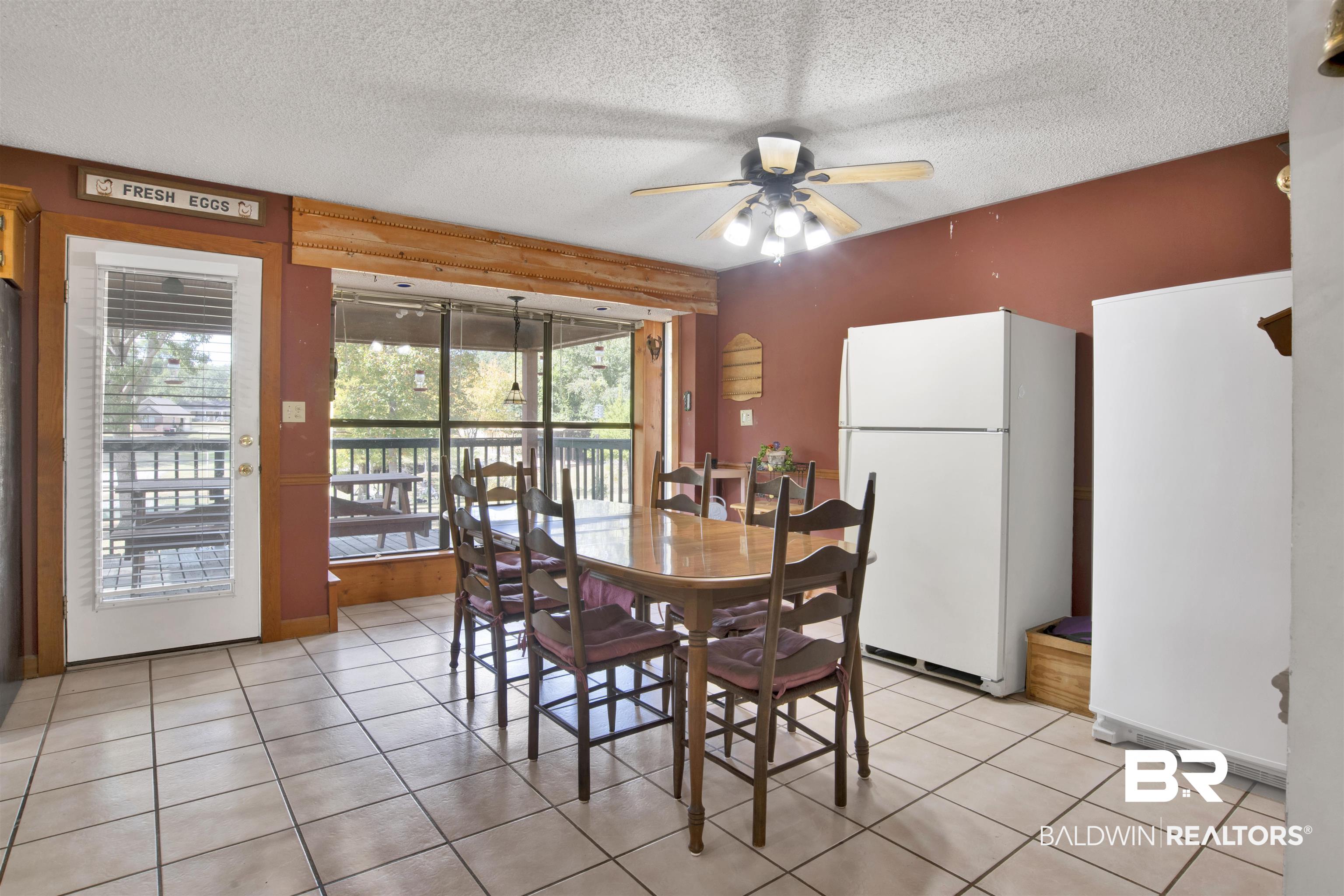 4890 Red Creek Road Semmes, AL 36575 - Photo 12 of 47 Dining room with ceiling fan, a textured ceiling, and light tile patterned flooring