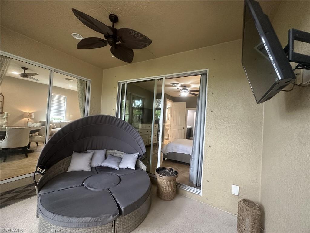13462 Kent Street Naples, FL 34109 - Photo 21 of 30 a bedroom with a bed and a chandelier